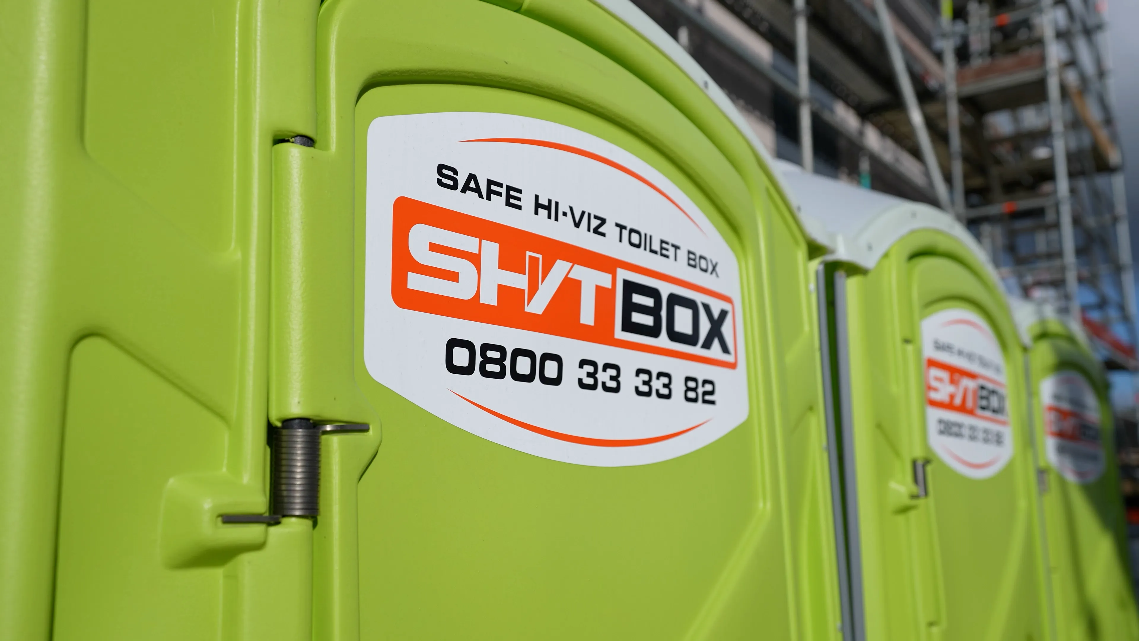SHVTBOX hi-vis portable toilets on a construction site