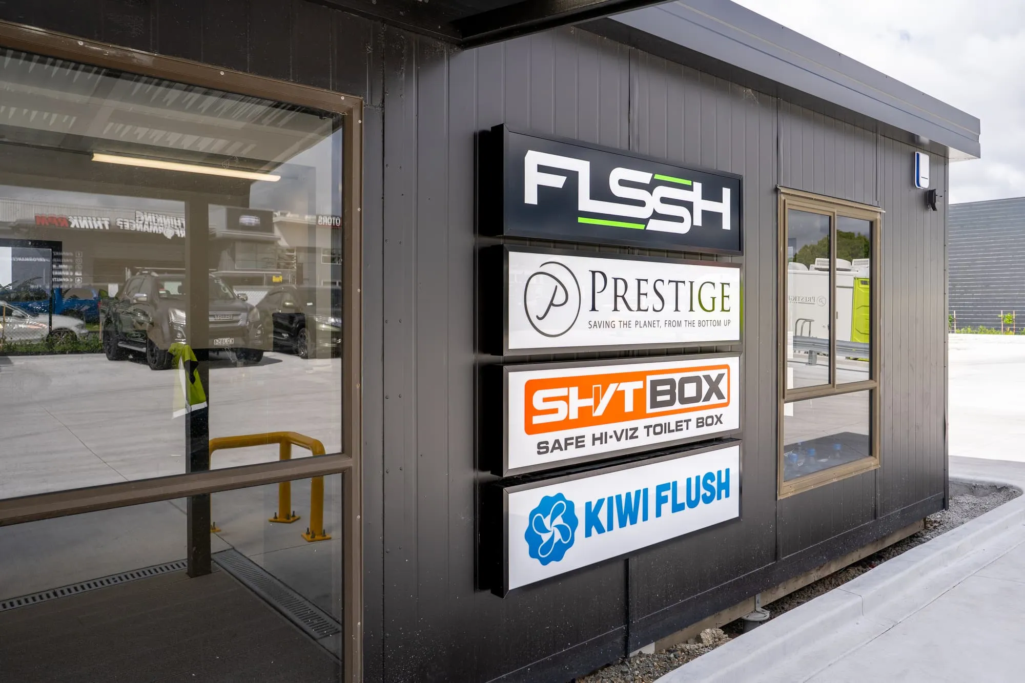 FLSSH, Prestige, SHVTBOX and Kiwi Flush signs on the front of the FLSSH office